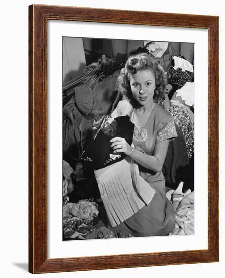 Actress Shirley Temple, Gathering Her Unwanted Clothes Together to Donate to a Clothing Drive-Martha Holmes-Framed Premium Photographic Print