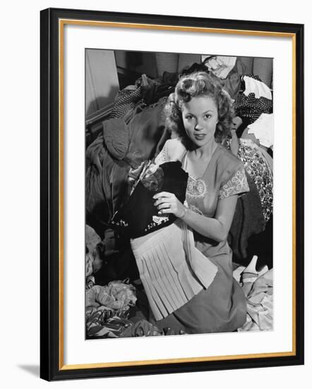 Actress Shirley Temple, Gathering Her Unwanted Clothes Together to Donate to a Clothing Drive-Martha Holmes-Framed Premium Photographic Print