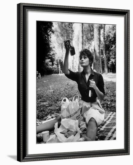 Actress Sophia Loren Examining Contents of Bottle During Location Filming of "Madame Sans Gene"-Alfred Eisenstaedt-Framed Premium Photographic Print