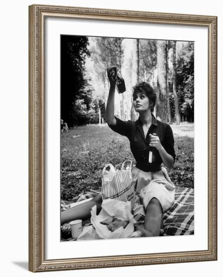 Actress Sophia Loren Examining Contents of Bottle During Location Filming of "Madame Sans Gene"-Alfred Eisenstaedt-Framed Premium Photographic Print