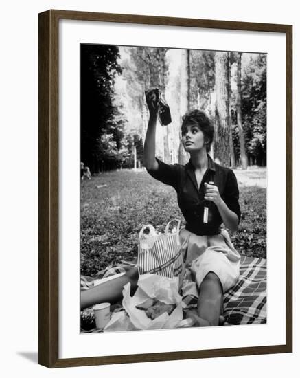Actress Sophia Loren Examining Contents of Bottle During Location Filming of "Madame Sans Gene"-Alfred Eisenstaedt-Framed Premium Photographic Print