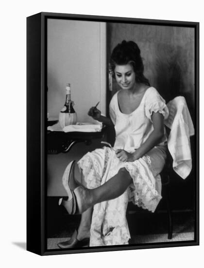 Actress Sophia Loren Looking at Her Foot While Eating During Filming of "Madame Sans Gene"-Alfred Eisenstaedt-Framed Premier Image Canvas