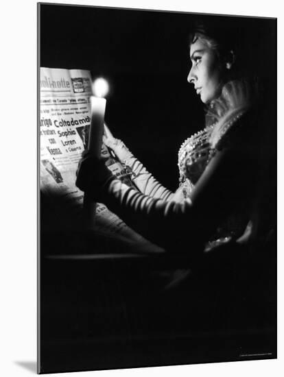 Actress Sophia Loren Reading Newspaper by Candlelight While in Costume for "Madame Sans Gene"-Alfred Eisenstaedt-Mounted Premium Photographic Print