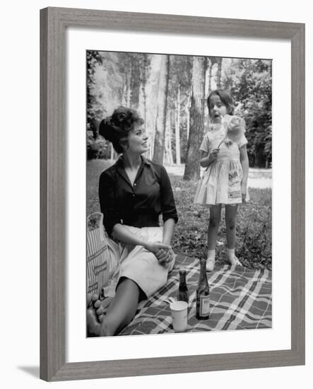Actress Sophia Loren with Girl Holding a Flower During Picnic While Filming "Madame Sans Gene"-Alfred Eisenstaedt-Framed Premium Photographic Print