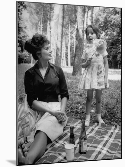 Actress Sophia Loren with Girl Holding a Flower During Picnic While Filming "Madame Sans Gene"-Alfred Eisenstaedt-Mounted Premium Photographic Print