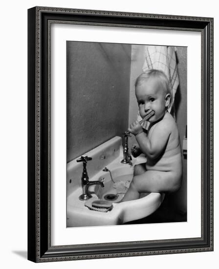 Adorable Baby Brushing Teeth While Sitting in Sink-null-Framed Photographic Print