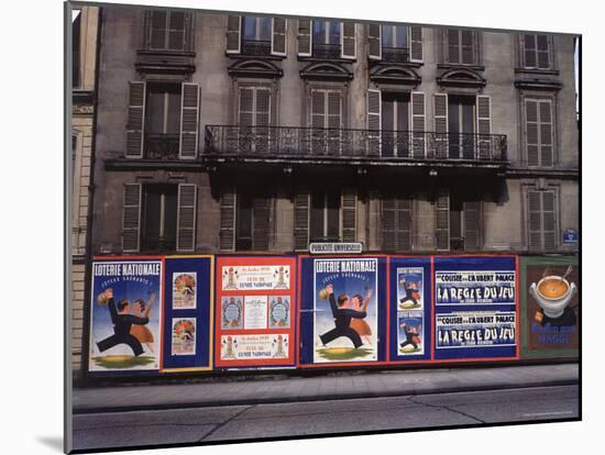 Advertising Posters Plastered on a Wall Along the Rue de Courcelles-William Vandivert-Mounted Photographic Print