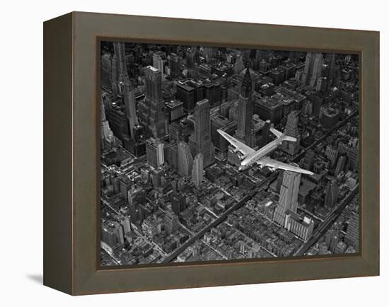 Aerial View of a DC-4 Passenger Plane Flying over Midtown Manhattan-Margaret Bourke-White-Framed Premier Image Canvas