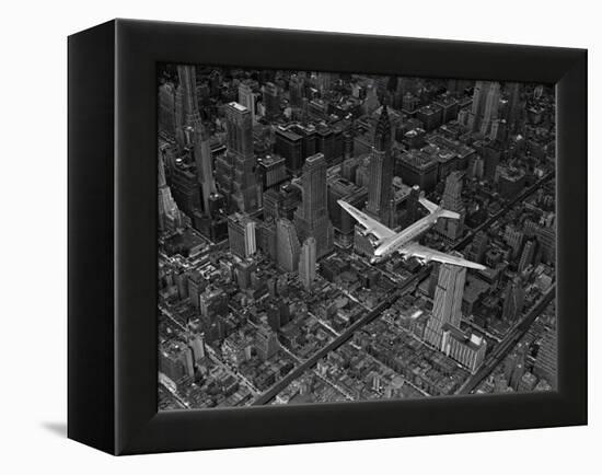 Aerial View of a DC-4 Passenger Plane Flying over Midtown Manhattan-Margaret Bourke-White-Framed Premier Image Canvas