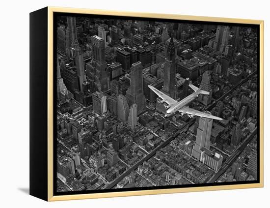 Aerial View of a DC-4 Passenger Plane Flying over Midtown Manhattan-Margaret Bourke-White-Framed Premier Image Canvas