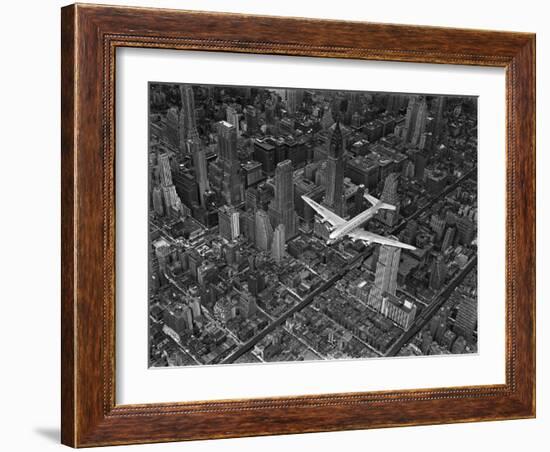 Aerial View of a Dc-4 Passenger Plane in Flight over Manhattan-Margaret Bourke-White-Framed Premium Photographic Print