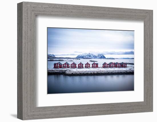 Aerial view of red rorbu cabins in a row amidst the cold sea in winter, Svolvaer, Nordland county-Roberto Moiola-Framed Photographic Print