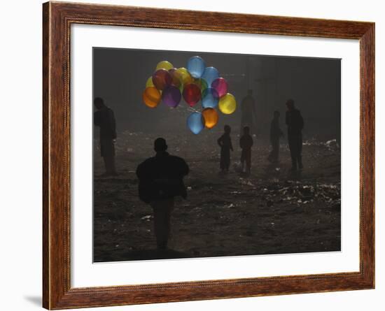 Afghan Boy Runs with Balloons to Join His Friends in Dusty Alley in Kabul, Afghanistan-null-Framed Photographic Print