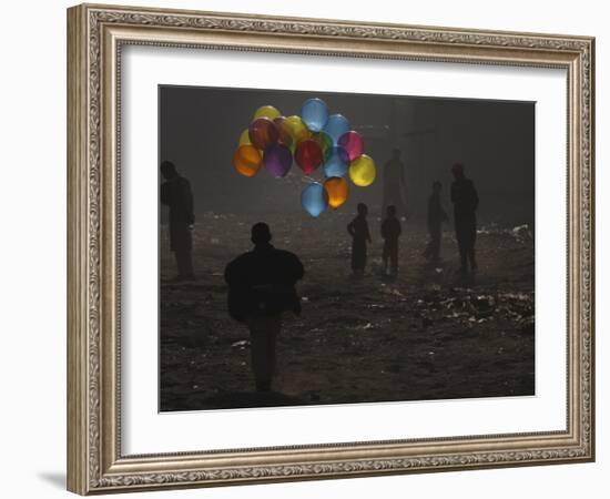 Afghan Boy Runs with Balloons to Join His Friends in Dusty Alley in Kabul, Afghanistan-null-Framed Photographic Print