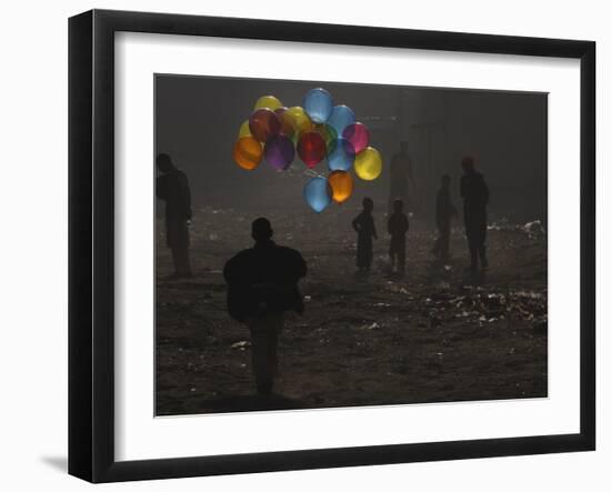 Afghan Boy Runs with Balloons to Join His Friends in Dusty Alley in Kabul, Afghanistan-null-Framed Photographic Print