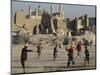 Afghan Boys Play Soccer Near a Mosque and Ruined Buildings During the Early Morning-null-Mounted Photographic Print