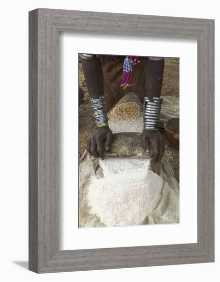 Africa, Ethiopia, Southern Omo, Karo Tribe. Woman grinding grain into flour with stone.-Ellen Goff-Framed Photographic Print