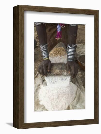 Africa, Ethiopia, Southern Omo, Karo Tribe. Woman grinding grain into flour with stone.-Ellen Goff-Framed Photographic Print