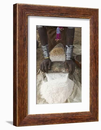 Africa, Ethiopia, Southern Omo, Karo Tribe. Woman grinding grain into flour with stone.-Ellen Goff-Framed Photographic Print