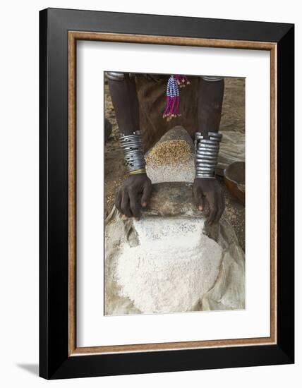 Africa, Ethiopia, Southern Omo, Karo Tribe. Woman grinding grain into flour with stone.-Ellen Goff-Framed Photographic Print