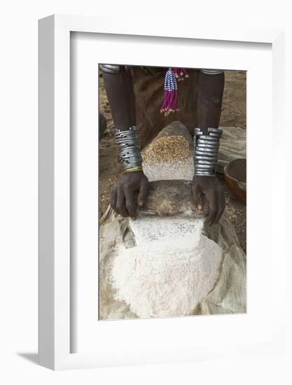 Africa, Ethiopia, Southern Omo, Karo Tribe. Woman grinding grain into flour with stone.-Ellen Goff-Framed Photographic Print