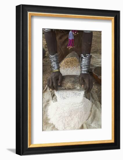 Africa, Ethiopia, Southern Omo, Karo Tribe. Woman grinding grain into flour with stone.-Ellen Goff-Framed Photographic Print