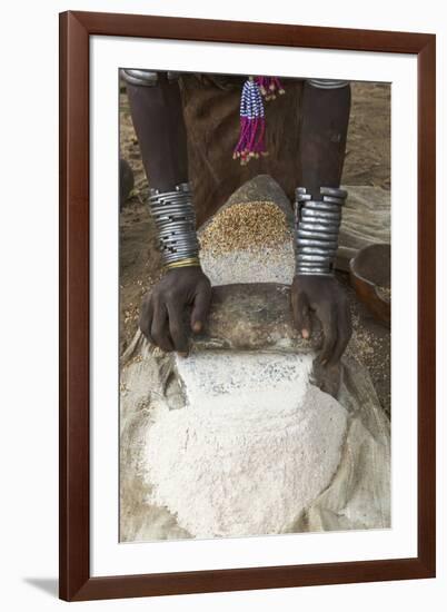 Africa, Ethiopia, Southern Omo, Karo Tribe. Woman grinding grain into flour with stone.-Ellen Goff-Framed Premium Photographic Print