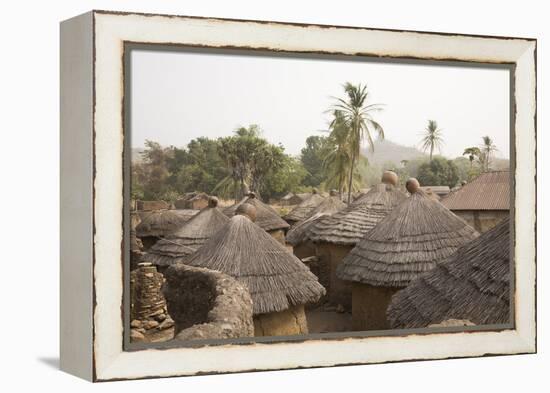 Africa, West Africa, Benin, Beri. Thatched rooves of traditional dwellings in front of palm trees.-Alida Latham-Framed Premier Image Canvas