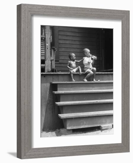 African American Boys at top of Stairs as Older Boy is Drinking Soda and Younger One Reaches for It-Alfred Eisenstaedt-Framed Photographic Print