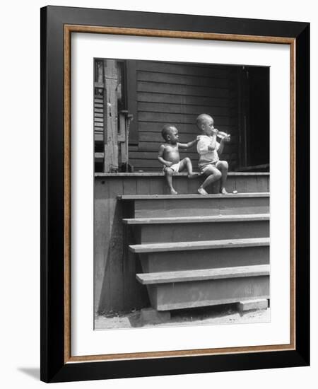 African American Boys at top of Stairs as Older Boy is Drinking Soda and Younger One Reaches for It-Alfred Eisenstaedt-Framed Photographic Print