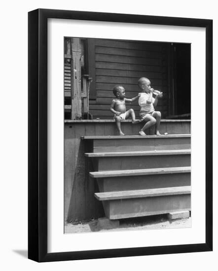 African American Boys at top of Stairs as Older Boy is Drinking Soda and Younger One Reaches for It-Alfred Eisenstaedt-Framed Photographic Print
