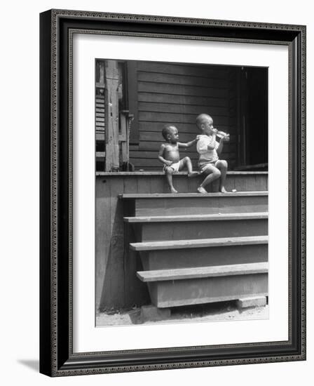 African American Boys at top of Stairs as Older Boy is Drinking Soda and Younger One Reaches for It-Alfred Eisenstaedt-Framed Photographic Print