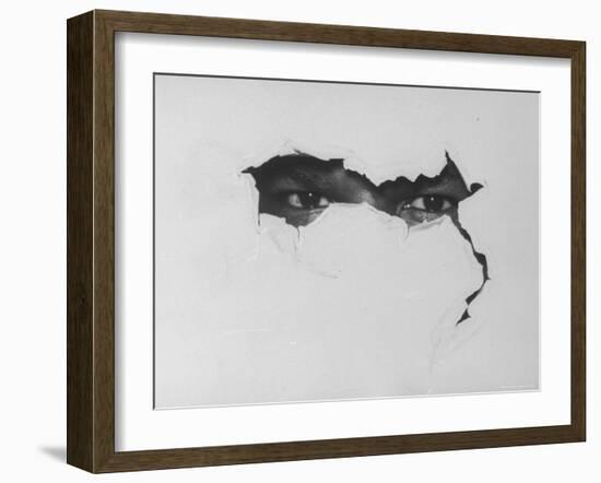 African American Man's Eyes Peering Through Torn Paper Symbolizing Hard Core Black Extremists-Ralph Morse-Framed Photographic Print