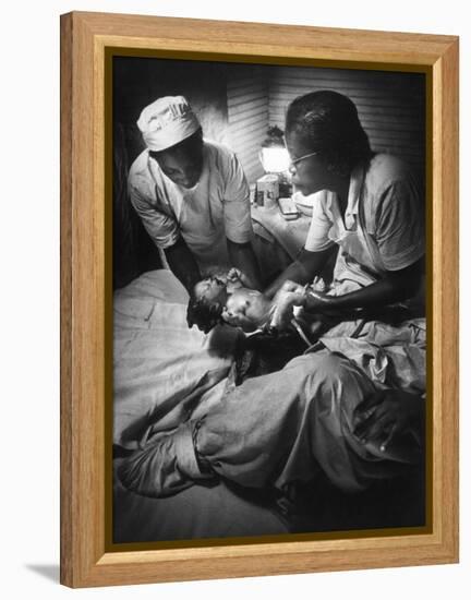 African American Midwife Maude Callen Delivering a Baby-W^ Eugene Smith-Framed Premier Image Canvas