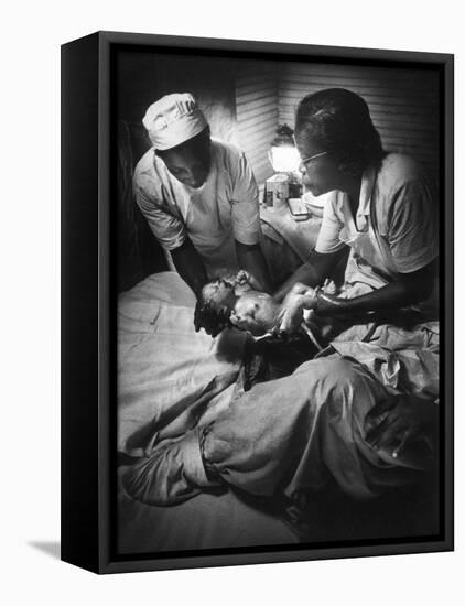 African American Midwife Maude Callen Delivering a Baby-W^ Eugene Smith-Framed Premier Image Canvas