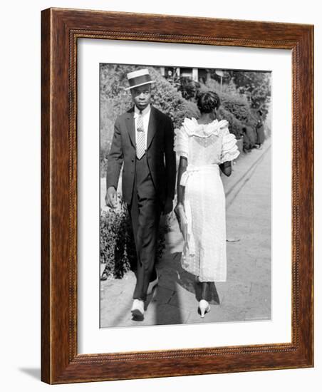 African American Sporting His Sunday Finery Glancing at Frilly Frocked Girl Passing Him on Street-Alfred Eisenstaedt-Framed Photographic Print