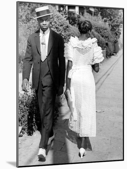 African American Sporting His Sunday Finery Glancing at Frilly Frocked Girl Passing Him on Street-Alfred Eisenstaedt-Mounted Photographic Print
