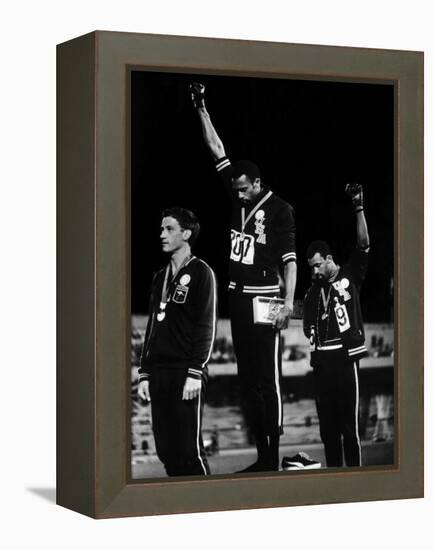 African American Track Star Tommie Smith, John Carlos After Winning Gold and Bronze Olympic Medal-John Dominis-Framed Premier Image Canvas