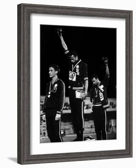 African American Track Star Tommie Smith, John Carlos After Winning Gold and Bronze Olympic Medal-John Dominis-Framed Premium Photographic Print