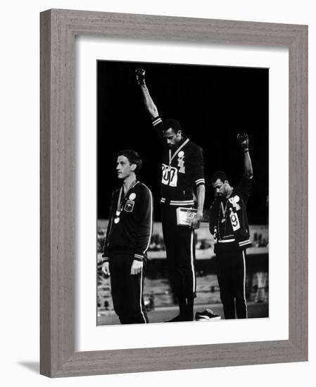 African American Track Star Tommie Smith, John Carlos After Winning Gold and Bronze Olympic Medal-John Dominis-Framed Premium Photographic Print