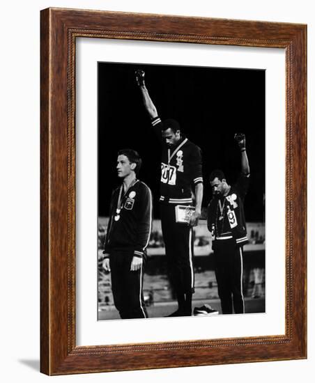 African American Track Star Tommie Smith, John Carlos After Winning Gold and Bronze Olympic Medal-John Dominis-Framed Premium Photographic Print