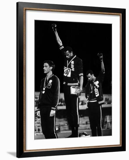 African American Track Star Tommie Smith, John Carlos After Winning Gold and Bronze Olympic Medal-John Dominis-Framed Premium Photographic Print