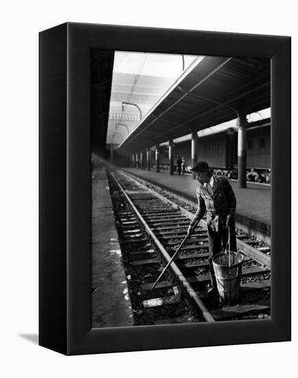 African American Woman Picking Up Debris on Tracks at Union Station-Alfred Eisenstaedt-Framed Premier Image Canvas