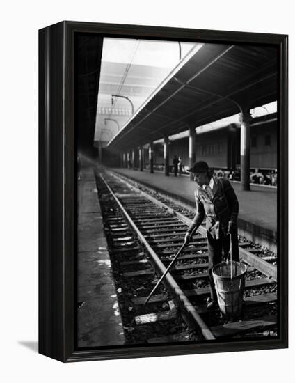 African American Woman Picking Up Debris on Tracks at Union Station-Alfred Eisenstaedt-Framed Premier Image Canvas