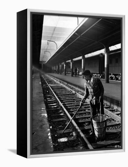 African American Woman Picking Up Debris on Tracks at Union Station-Alfred Eisenstaedt-Framed Premier Image Canvas