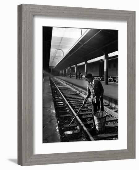 African American Woman Picking Up Debris on Tracks at Union Station-Alfred Eisenstaedt-Framed Photographic Print