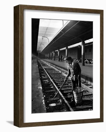 African American Woman Picking Up Debris on Tracks at Union Station-Alfred Eisenstaedt-Framed Photographic Print