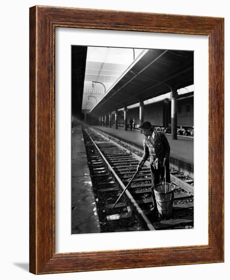 African American Woman Picking Up Debris on Tracks at Union Station-Alfred Eisenstaedt-Framed Photographic Print