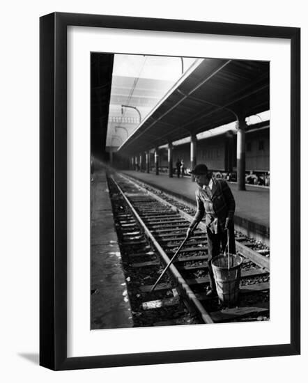 African American Woman Picking Up Debris on Tracks at Union Station-Alfred Eisenstaedt-Framed Photographic Print