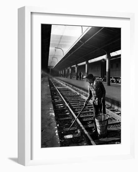 African American Woman Picking Up Debris on Tracks at Union Station-Alfred Eisenstaedt-Framed Photographic Print